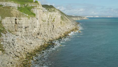 4K-Panoramic-landscape-panning-shot-of-the-cliffs-of-the-island-of-Portland-in-Dorset,-on-the-English-coast-line,-on-a-sunny-day