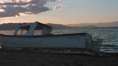 Boat-wreck-By-The-Beach-On-A-Beautiful-Sunset---medium-shot