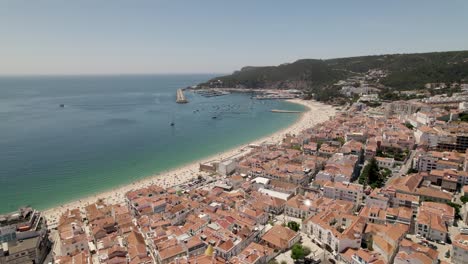 Sesimbra,-aerial-view-of-beach-and-cityscape-against-the-marina-and-hills