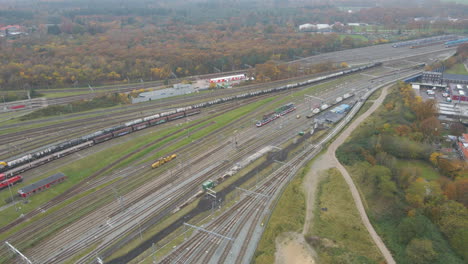 Aerial-of-a-long-cargo-train-driving-slowly-over-railway