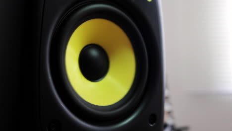 Close-up-at-moving-sub-woofer-with-yellow-membrane