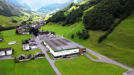 Slow-high-aerial-orbiting-shot-of-mineral-water-plant-in-Elm,-Glarus,-Switzerland