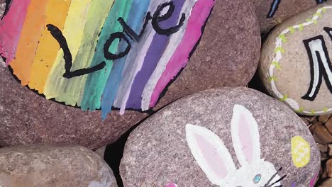 Pan-from-a-painted-rock-with-Easter-bunny-to-rainbow-color-heart-framing-the-word-love