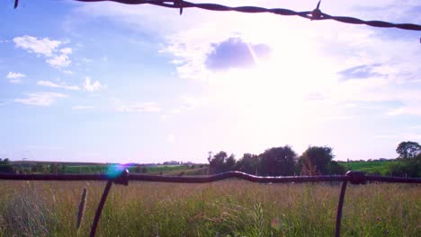4K-Timelapse-clouds-through-the-rusty-fence-reveal-50-percent-speed