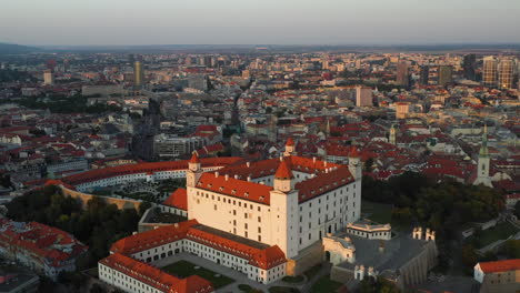 Slow-revealing-drone-shot-of-the-Bratislava-Castle-in-Bratislava-Slovakia,-during-golden-hour
