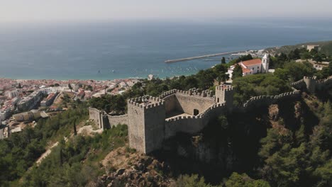 Castle-of-Sesimbra-or-of-Moors-and-port-in-background,-Portugal