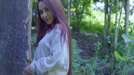 Close-up-descending-view-of-a-red-hair-girl-in-a-forested-park-on-a-tropical-island