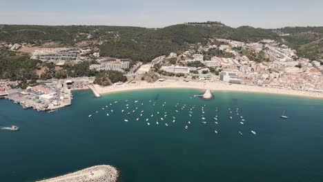 Motorboats-and-yachts-anchored-on-calm-Atlantic-Ocean-off-Ouro-Beach,-Sesimbra