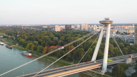 Wide-rotating-drone-shot-of-the-Bridge-of-the-Slovak-National-Uprising-in-Bratislava,-Slovakia