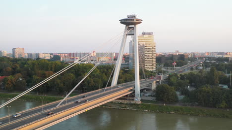 Cinematic-rotating-drone-shot-of-the-Bridge-of-the-Slovak-National-Uprising-in-Bratislava,-Slovakia