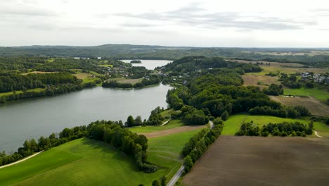 Brodno-Wielkie-lake-vicinity-with-forests-belts-and-countryside-roads-Aerial-pull-back