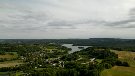 Brodno-Wielkie-lake-vicinity-with-endless-green-forest-in-Poland-Aerial-view-on-cloudy-day
