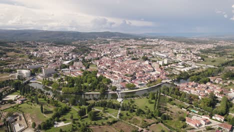 Aerial-wide-orbiting-shot-over-Chaves-Cityscape-surrounded-by-Nature,-Cloudy-day
