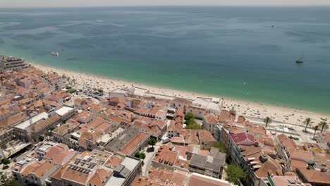 Sesimbra-beach-in-summer-season,-Portugal.-Aerial-orbit