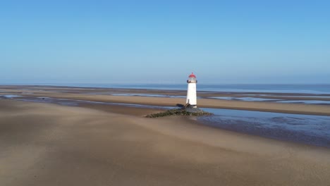 Talacre-red-top-dome-lighthouse-golden-sandy-low-tide-beach-sunrise-aerial-pull-back-view