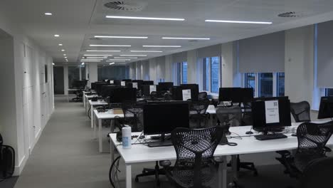Rows-Of-Empty-Desks-In-Office-Building