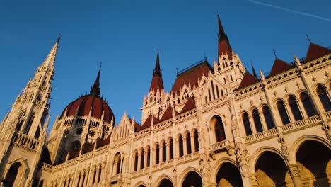 Hungary-Parliament-Building-On-The-Danube-River-during-golden-in-hand-held-shot