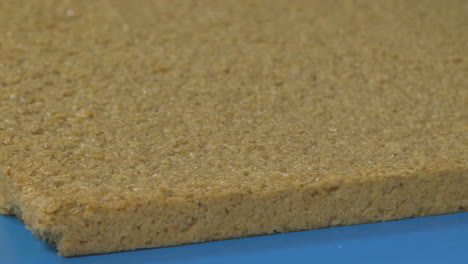 Large-slice-of-flapjack-moves-along-a-conveyor-built-ready-for-factory-production