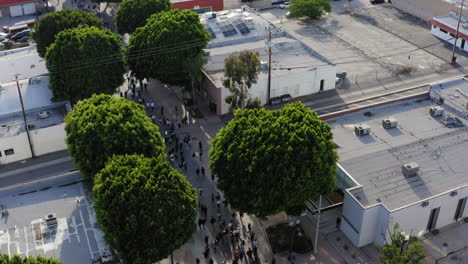 Aerial-shot-pans-over-large-crowd-marching-for-Black-Lives-Matter-Protest-in-Whittier-California,-United-States-of-America