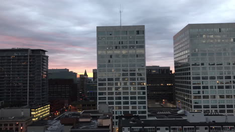 Wide-city-time-lapse-of-Ottawa-buildings-and-fast-moving-clouds,-going-from-day-to-night,-fiery-to-dark-in-nature