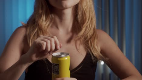 Girl-is-opening-a-can-with-juice-drink