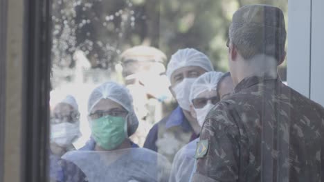 Doctors,-nurses-and-surgeons-wait-outside-of-a-contaminated-hospital
