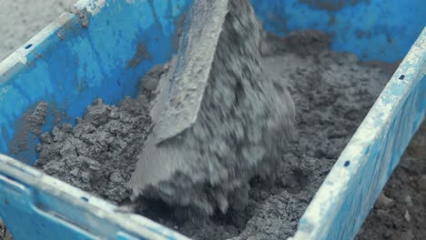 Using-shovel-mixing-cement-in-bucket-CLOSE-UP-SLOW-MOTION