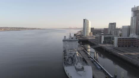 Liverpool-waterfront-aerial-orbit-right-view-royal-navy-military-ship-sunrise-high-rise-buildings-skyline