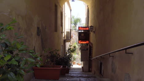 Entrance-to-the-Italian-restaurant-in-an-empty-alley-with-plants