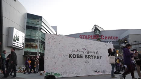 Fans-Give-Tribute-at-Staples-Center-Kobe-Bryant-Memorial,-Low-Angle-Shot,-Slow-Motion