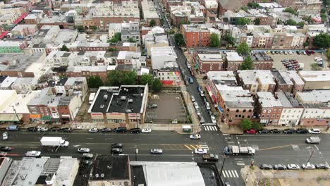 Aerial-truck-shot,-American-busy-urban-scene-in-USA,-traffic-on-street,-homes-and-neighborhood-community-establishing-shot