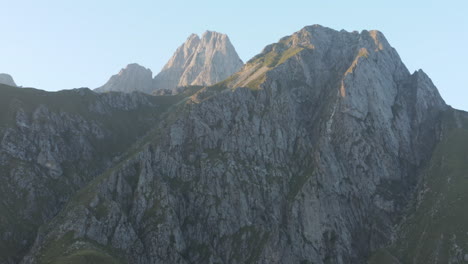 4k-UHD-drone-tilt-up-reveal-mountain-peaks-at-late-sunset-in-northern-italy