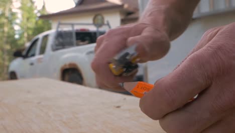 A-Contractor-Sharpens-His-Pencil-Using-A-Knife