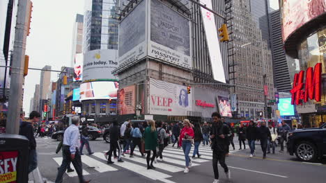 A-large-crowd-of-pedestrians-crossing-a-busy-intersection-in-Times-Square,-New-York
