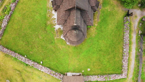 Aerial-View-Of-The-Gol-Stave-Church-On-The-Lush-Field-In-Oslo,-Norway---top-down-shot