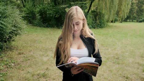girl-in-the-woods-flips-through-a-book