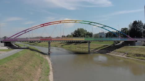Colorful-rainbow-Narutowicz-Bridge-over-Wislok-river-in-Rzeszow,-Poland