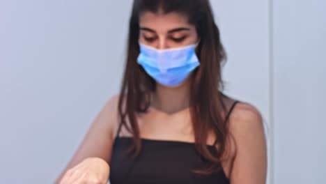 Young-woman-cooking-food-for-delivery-in-protective-mask