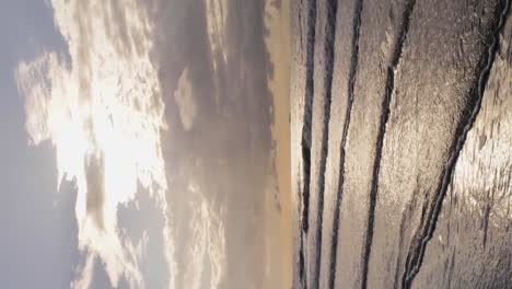 Vertical-drone-shot-of-waves-washing-ashore