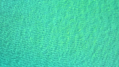 calm-clear-ocean-water-disturbed-by-a-small-wave-at-the-end