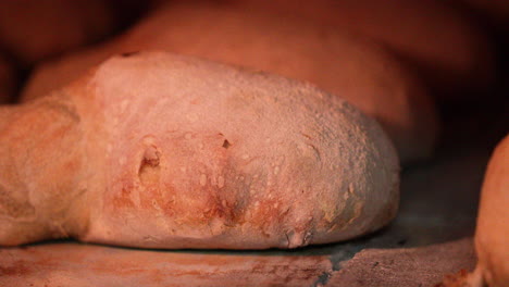 Bread-Cooking-Inside-A-Hot-Brick-Stone-Oven-At-The-Bakery---close-up