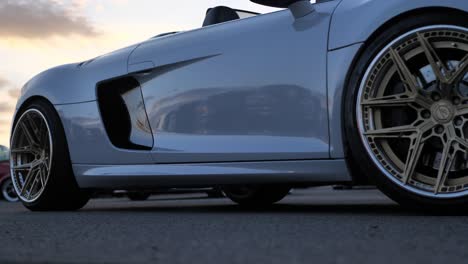 Driving-Luxury-Sports-Cars-on-Road-in-Twilight,-Low-Angle-Close-Up-View