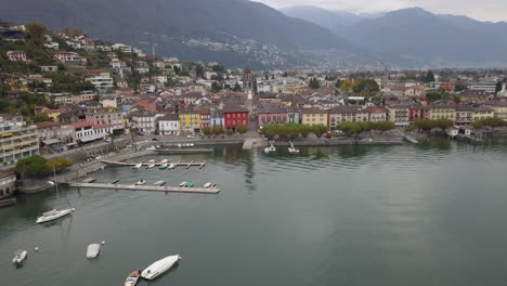 Aerial-backward-of-Ascona-cityscape-on-shores-of-Maggiore-Lake