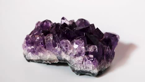 Still-shot-of-Purple-Amethyst-druse-crystal-in-white-background