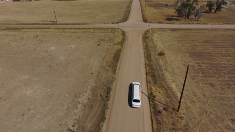 A-limousine-drives-down-a-country-road-shot-taken-from-drone