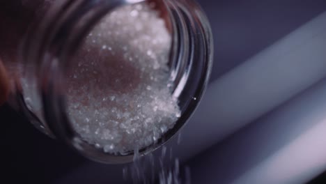 Pouring-White-Coarse-Sugar-From-A-Jar---Close-Up-Shot