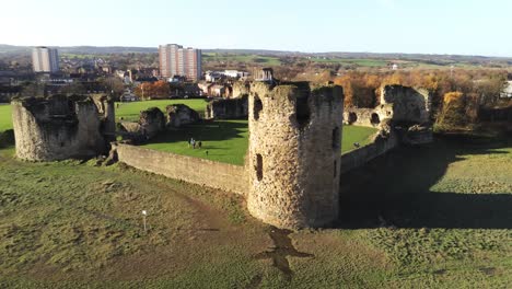 Ancient-Flint-castle-medieval-heritage-military-Welsh-ruins-aerial-view-landmark-closeup-to-pull-away-left