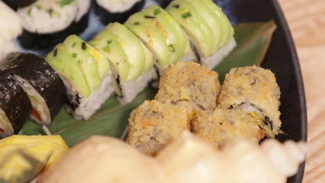 Mixed-Serving-Of-Fresh-Sushi-Drizzled-With-Oyster-Sauce-In-A-Platter---Closeup-Shot-Slow-Motion