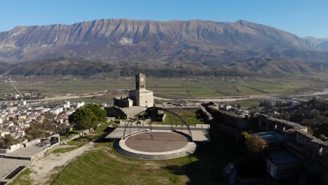 Panoramic-view-from-castle-of-Gjirokastra-with-stone-tower-over-city-and-mountain-background