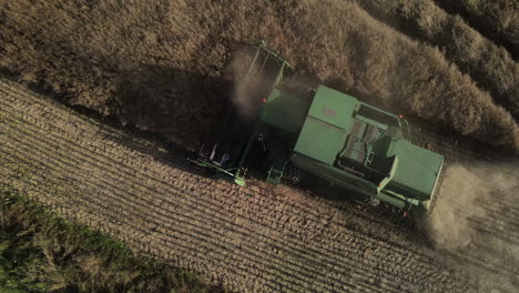 Closeup-of-a-huge-green-combine-harvester-cutting-wheat-crops